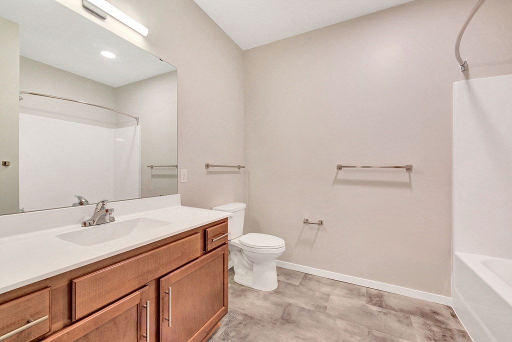 a bathroom with a sink toilet and a mirror