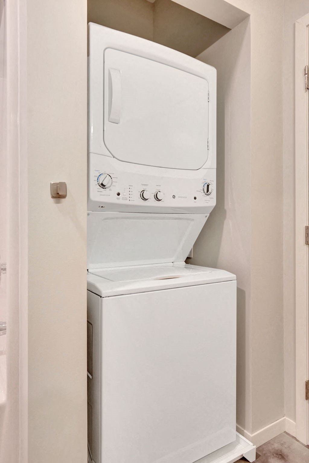 a small laundry room with a washer and dryer in the door
