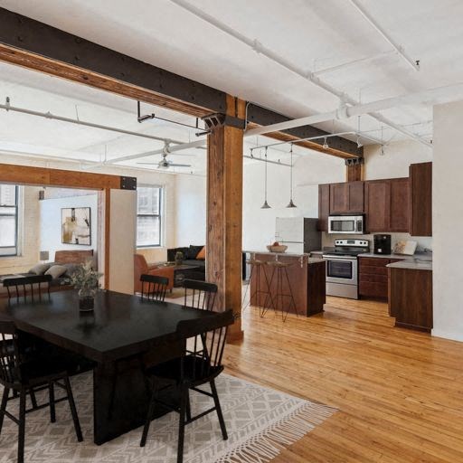 a kitchen and dining room with wood floors and exposed beams
