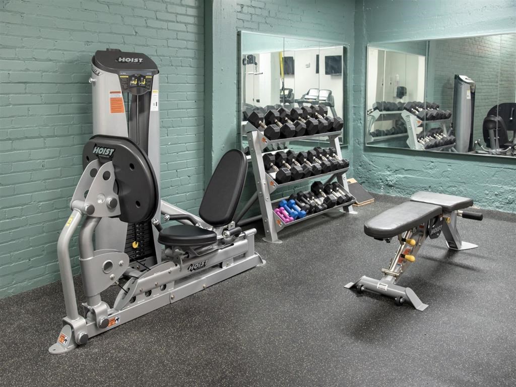 fitness center with bench and dumbbells