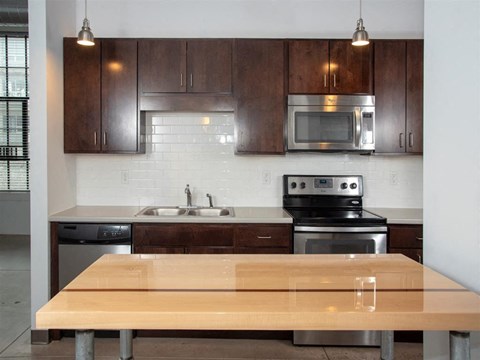 kitchen with movable island and stainless steel appliances
