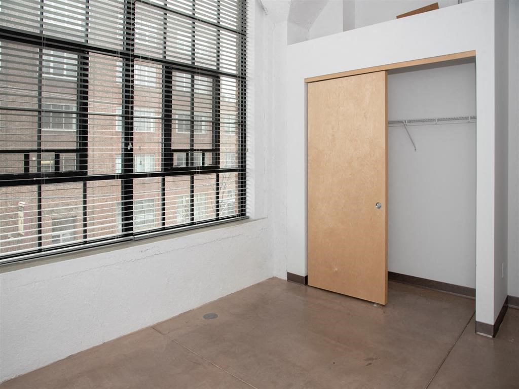 bedroom with closet and large window