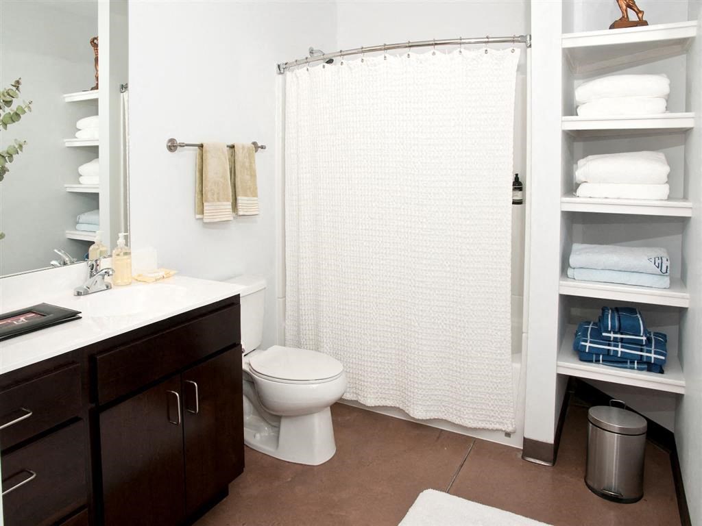 bathroom with bathtub and linen storage