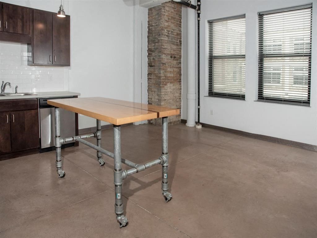 movable island and living room with exposed brick column