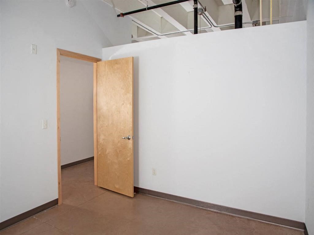 Bedroom with partial wall and door