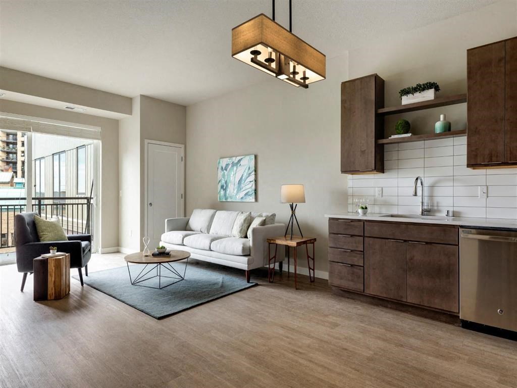 apartment with modern cabinets, backsplash and living room furniture