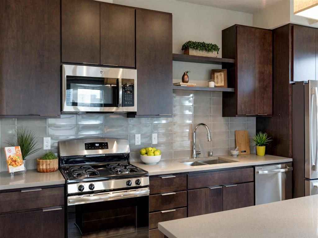 Kitchen with stainless steel appliances and tile backsplash