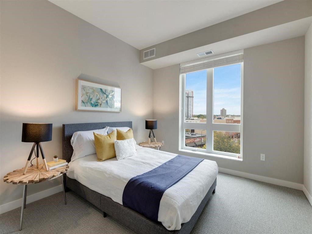 Carpeted bedroom with bed and great view