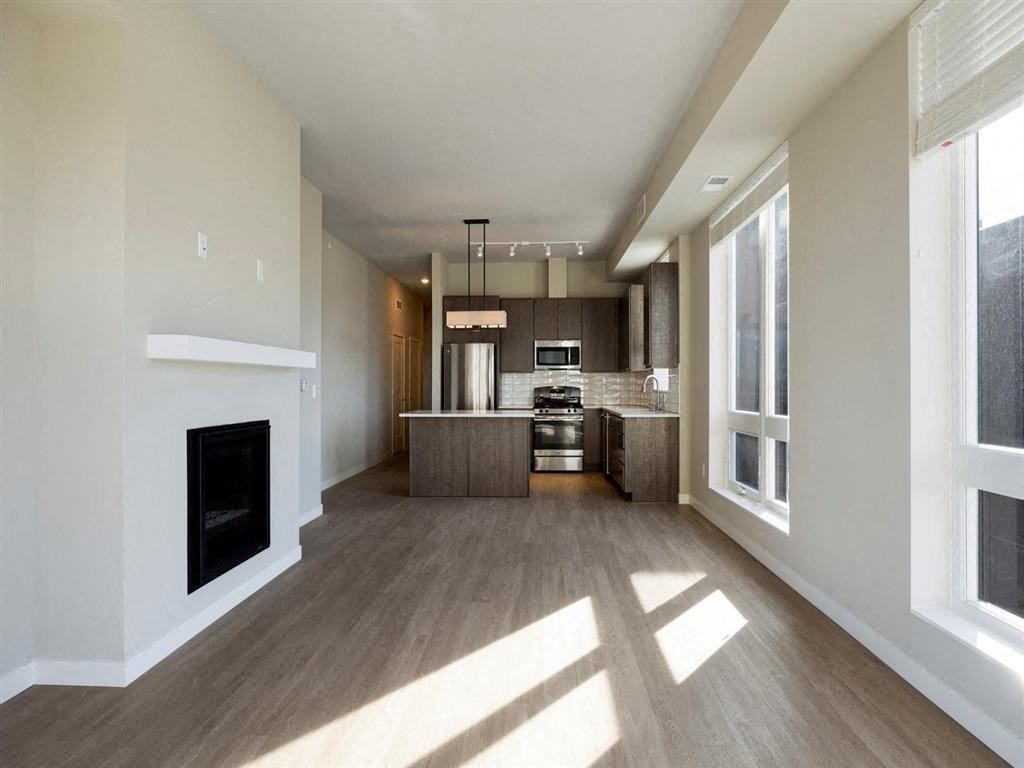 Living room with fireplace and kitchen
