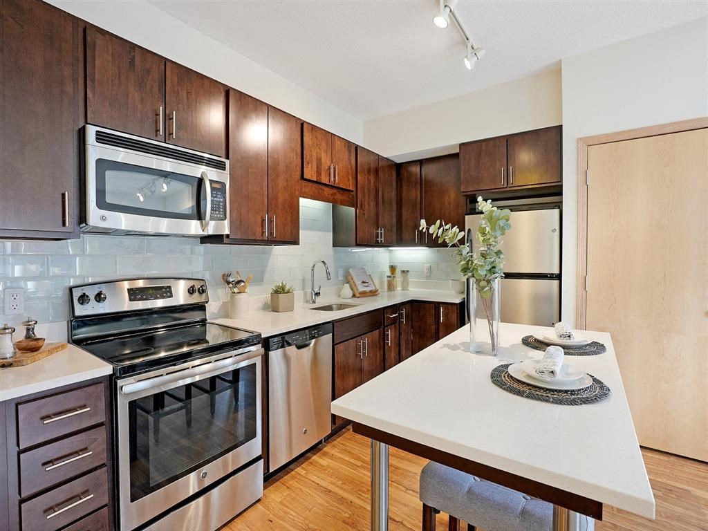 Dark cabinets and stainless steel appliances
