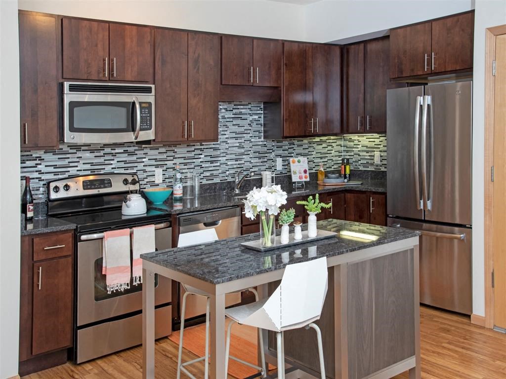 renovated apartment with glass tile backsplash