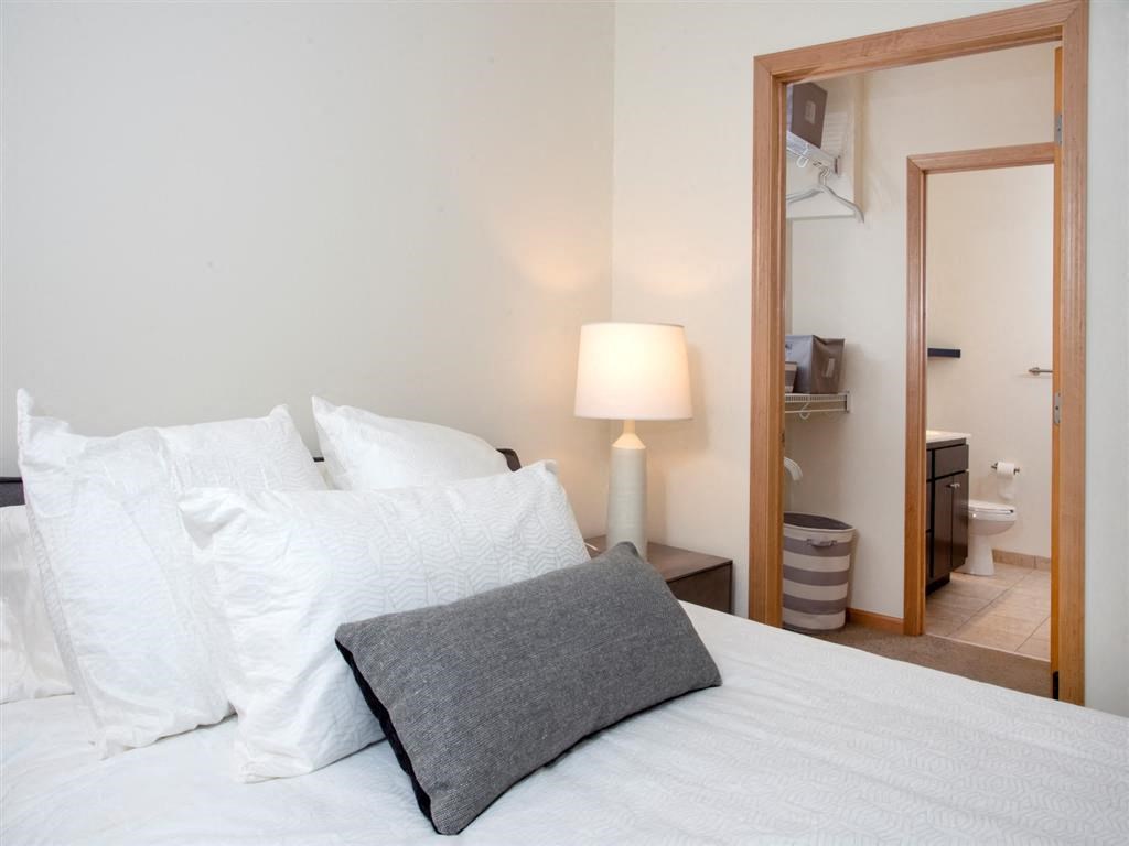 bedroom with attached bathroom and walk in closet