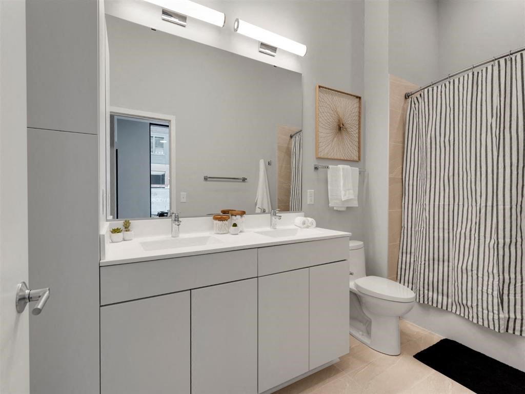 modern bathroom with tile and double sink vanity