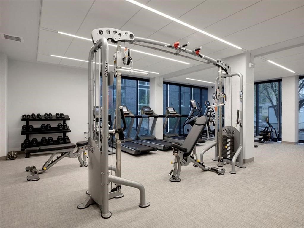 Fitness center with large windows and cable machine