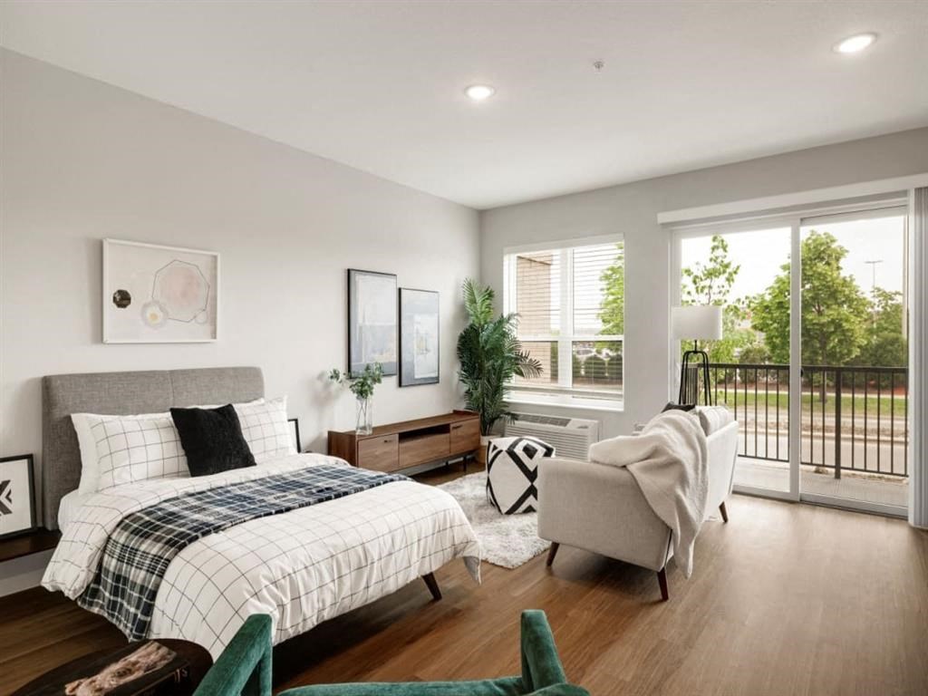 a bedroom with a bed sitting next to a window