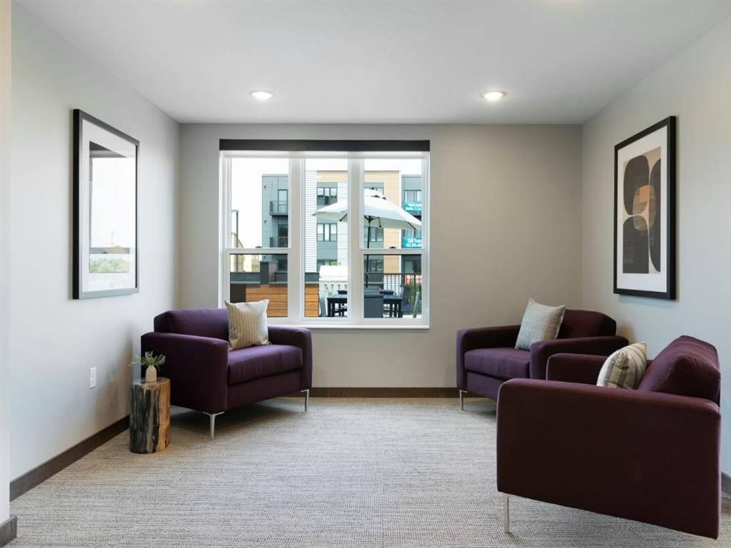a living room with two purple chairs and a large window