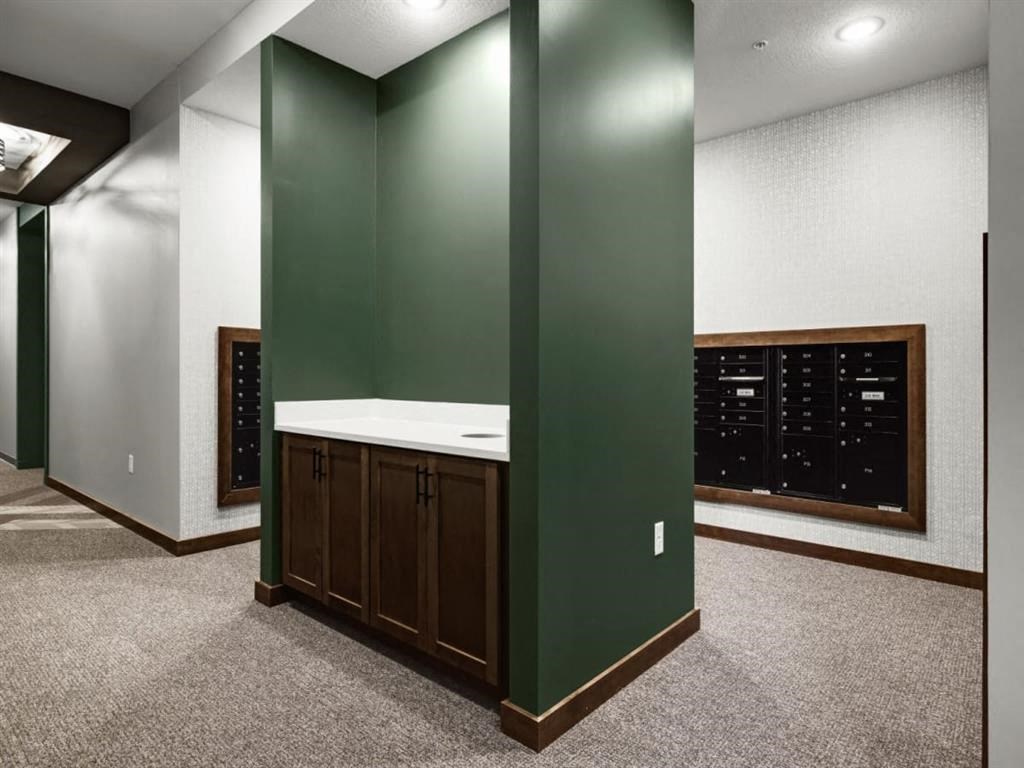 a large room with green walls and a white sink in the middle of it