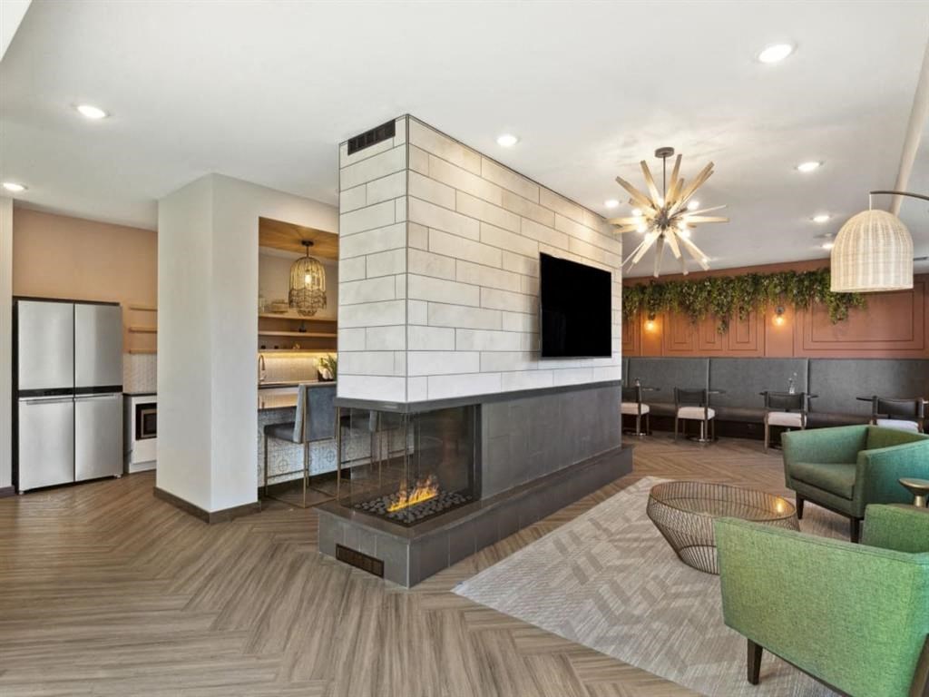 a living room with a fireplace and a flat screen tv