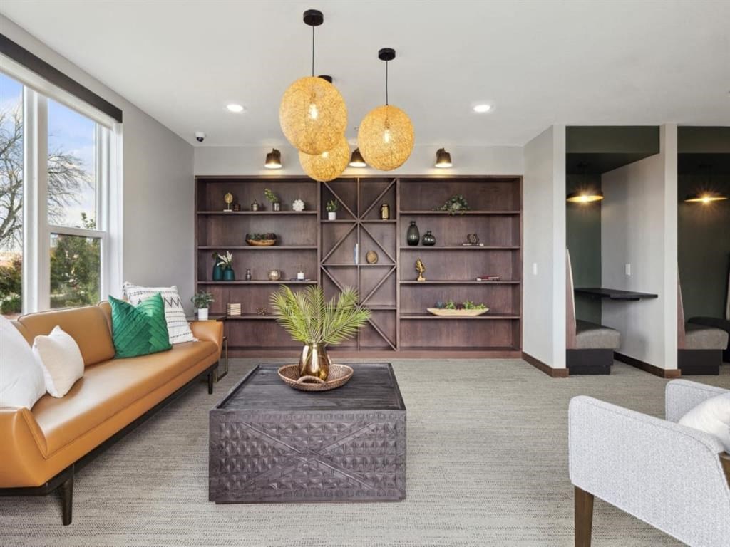 a living room filled with furniture and a large window
