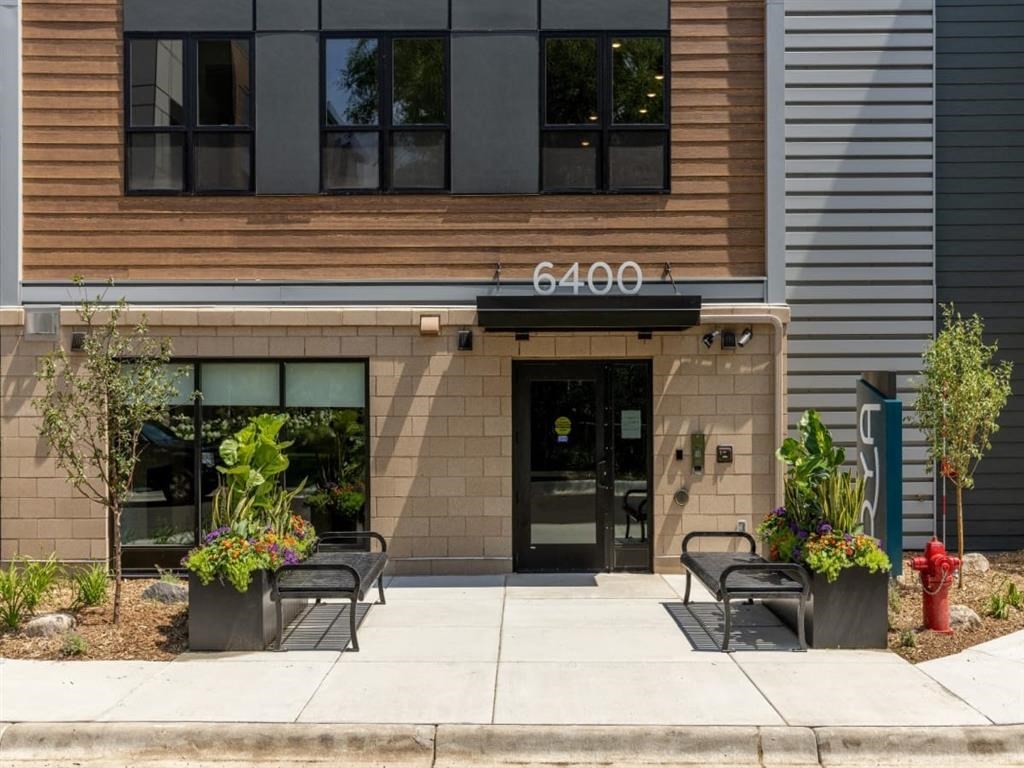 a building with two benches and a fire hydrant in front of it