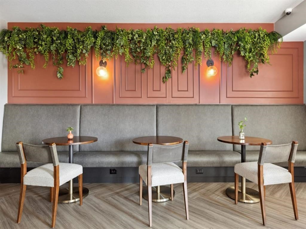 a restaurant with a garland of ivy on the wall