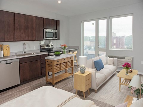 a living room with a kitchen and a couch