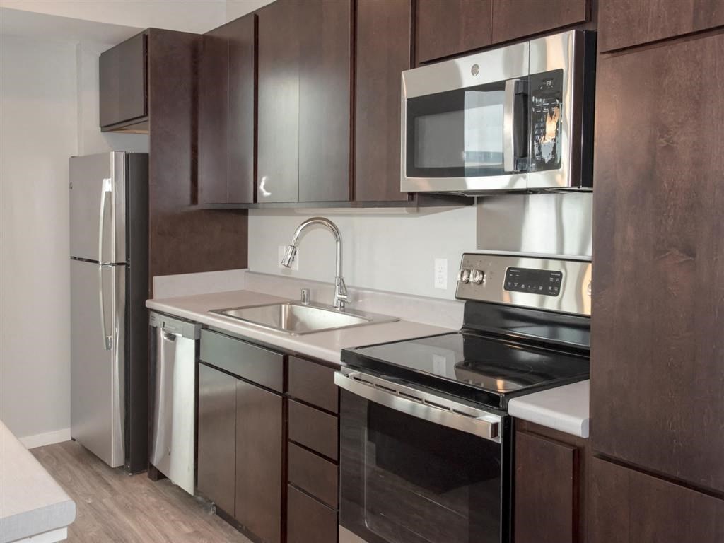 Kitchen with espresso cabinets and stainless steel appliances