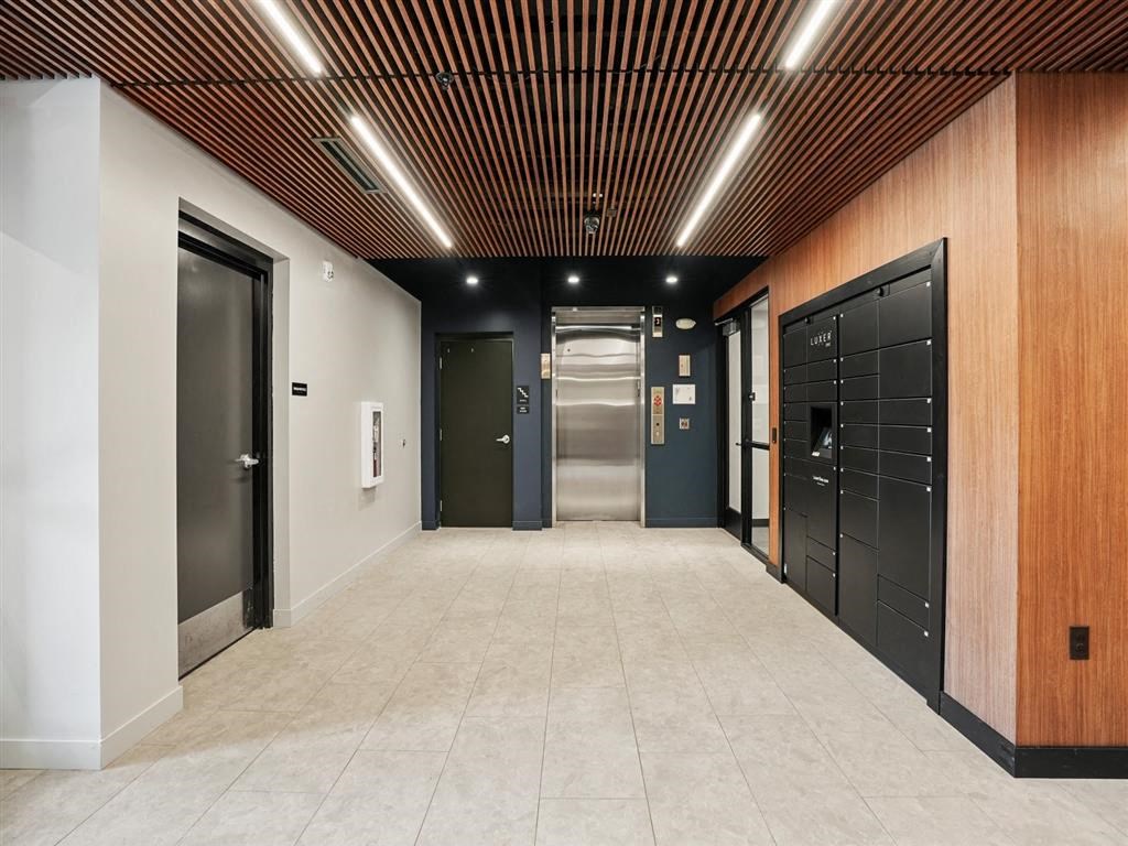 a hallway with black doors and white walls