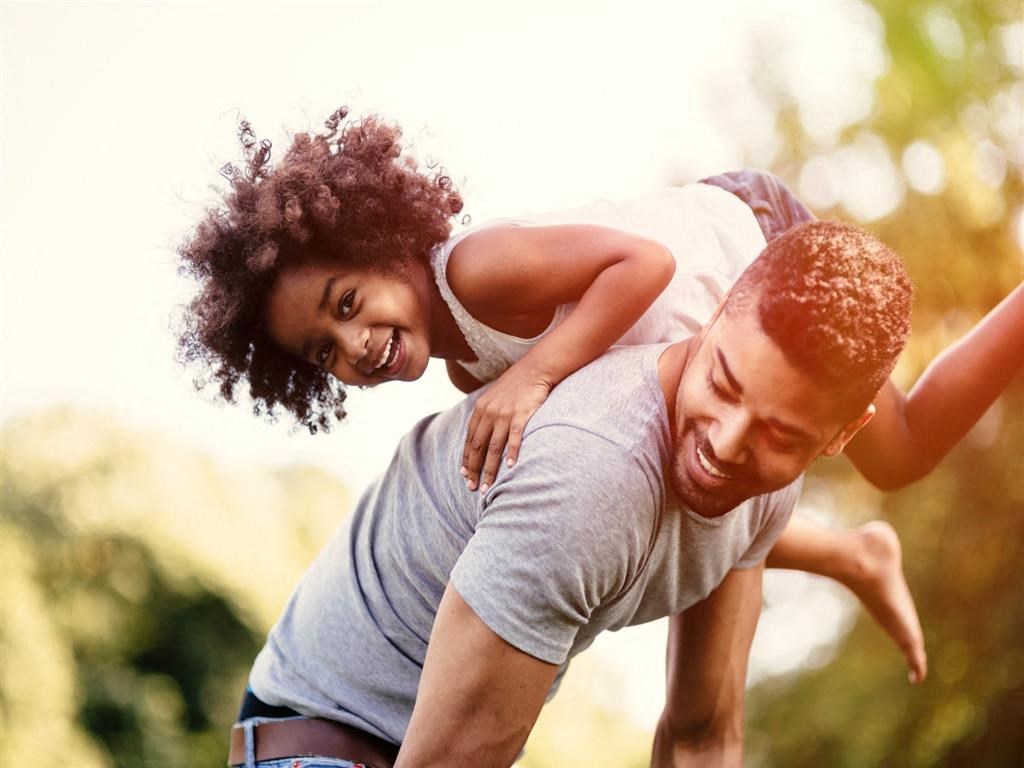 a father and daughter playing in the park