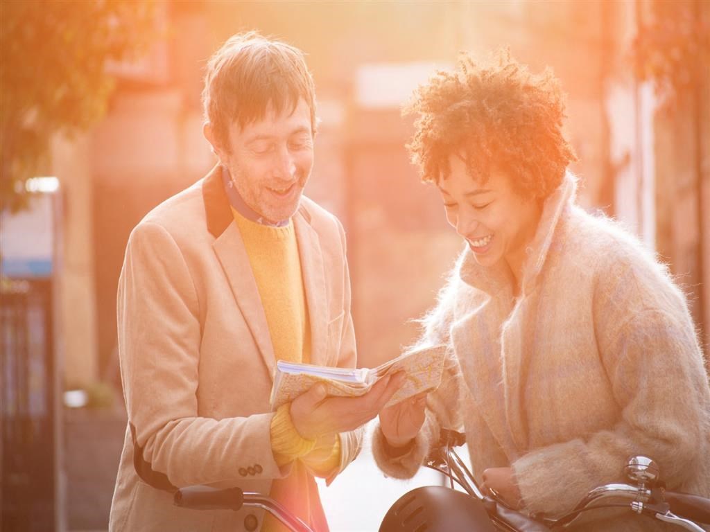 a man and a woman looking at a map