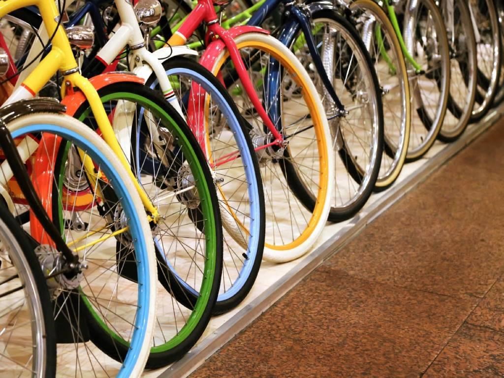 a row of colorful bikes on a rack