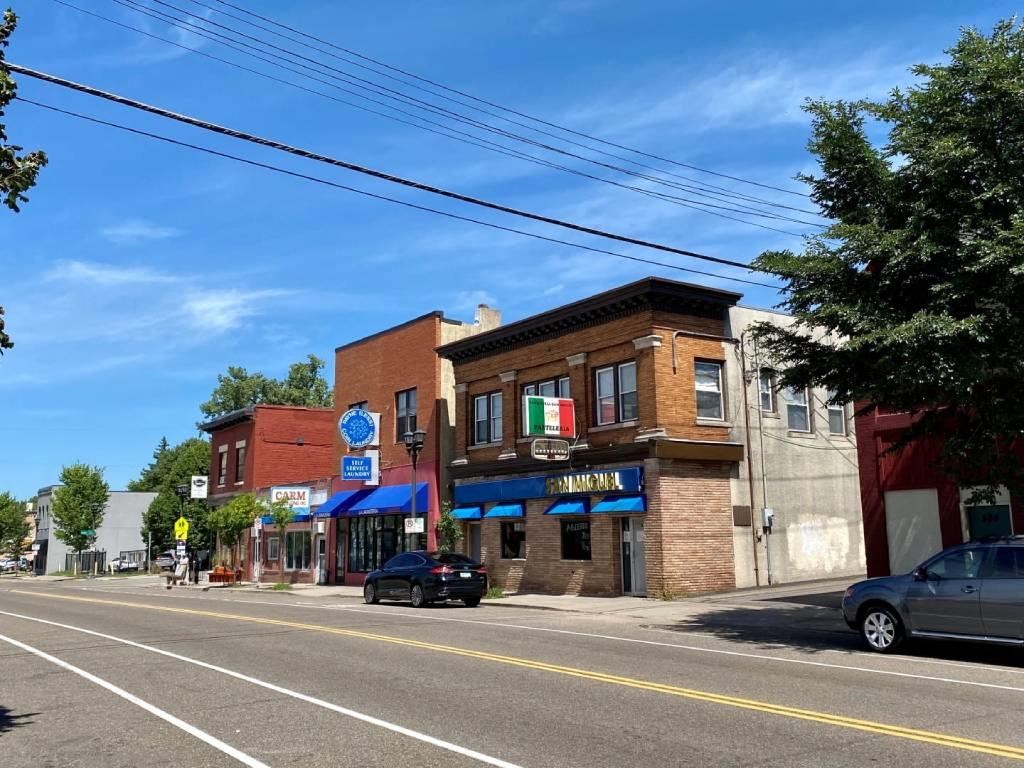 a city street with cars parked on the side of the road
