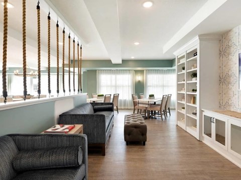 a living room and dining room with a table and chairs