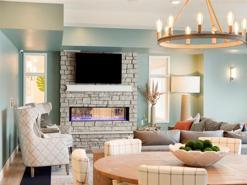 Clubroom with fireplace, large TV and seating