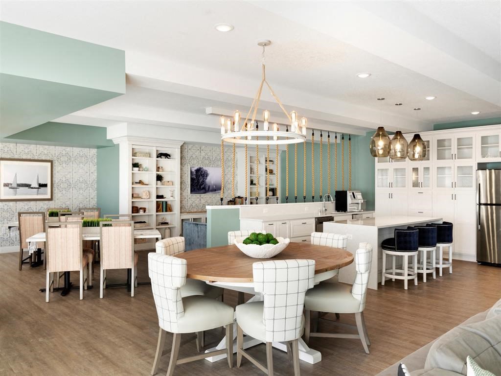 Clubroom with round dining table and chandelier