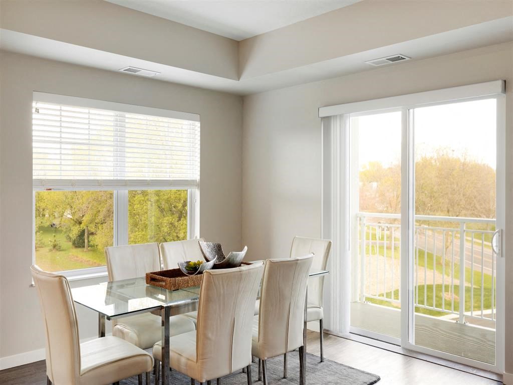 corner dining room with window and patio door