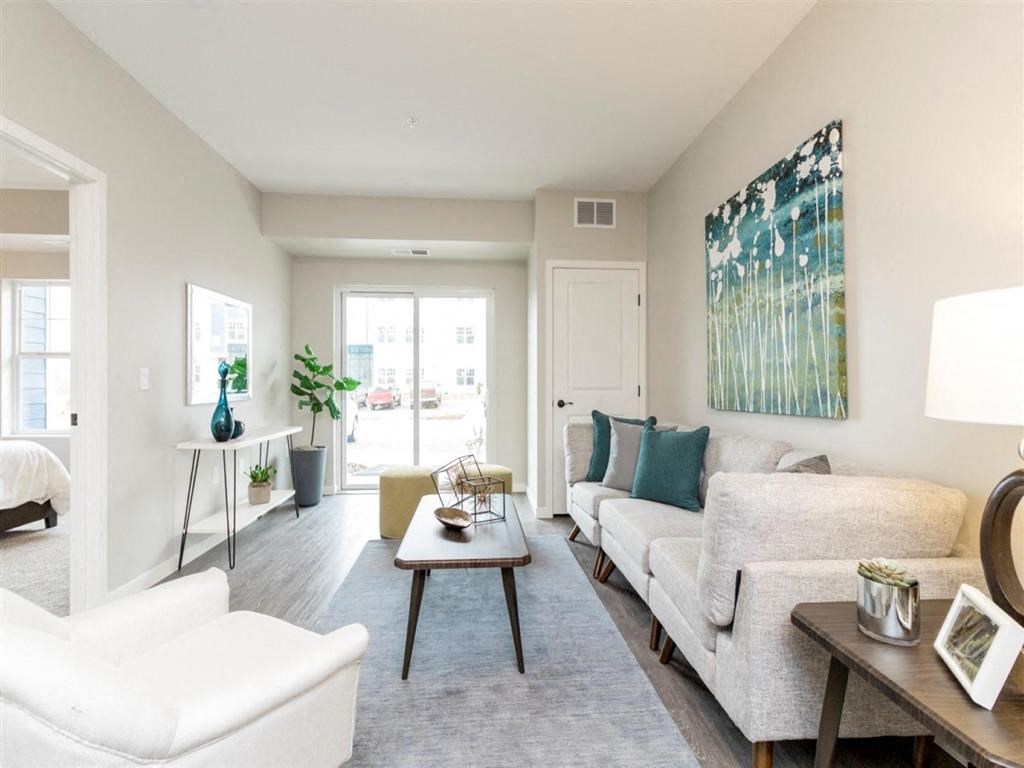 Living room with couch, coffee table and patio door