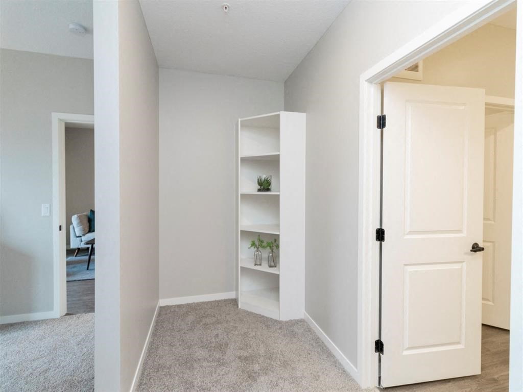 Den of home office nook with white bookshelf