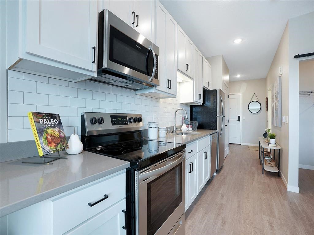white kitchen with stainless steel appliances