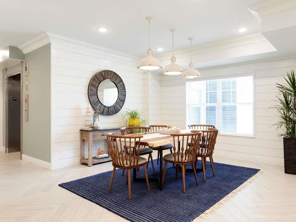 Wood dining table in light and airy lobby