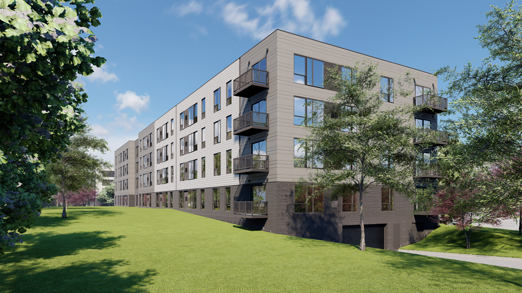 a large apartment building with a green lawn and trees