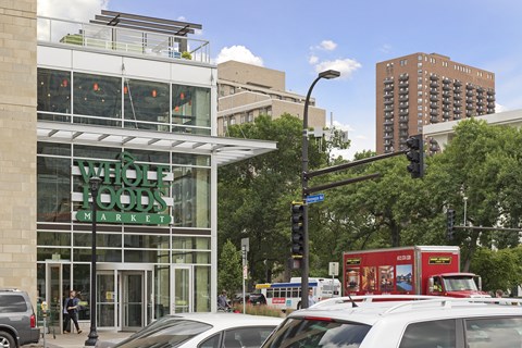 a large glass building with a sign that reads whole foods market