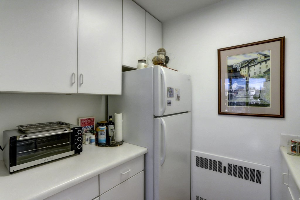 a kitchen with a refrigerator and a toaster oven