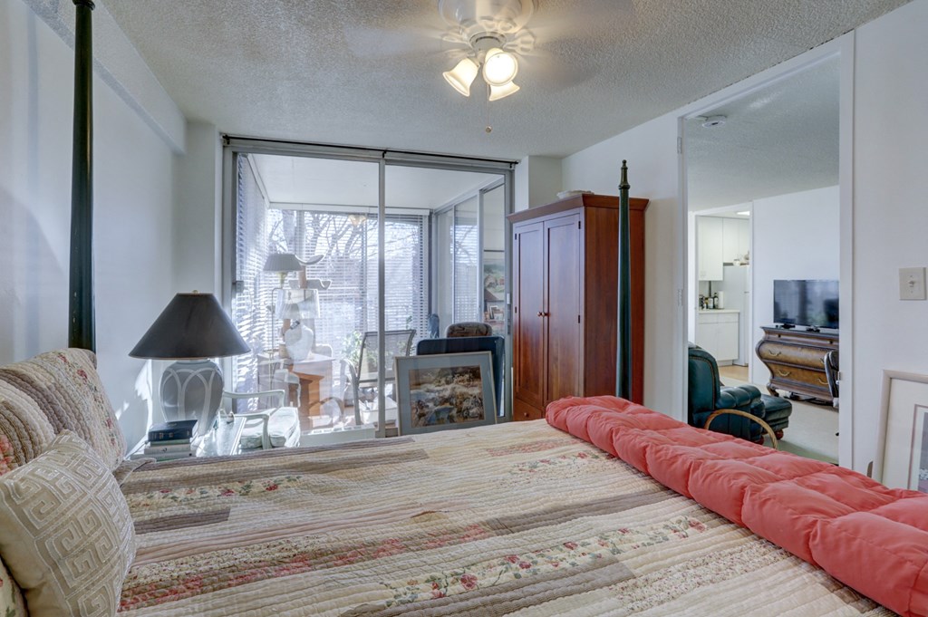 a bedroom with a large bed and a living room with a tv