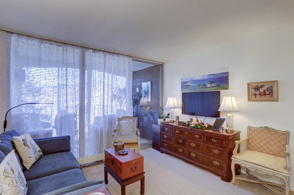 a living room with a couch and a dresser