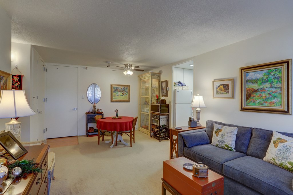 a living room with a red table and a couch