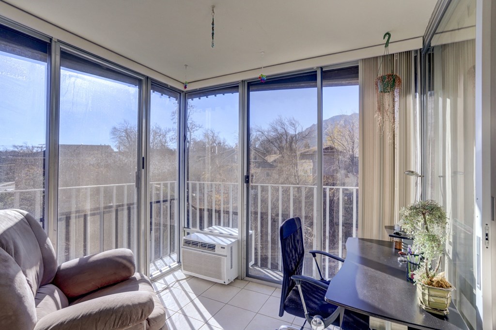 a living room with a couch and a table with chairs and sliding glass doors