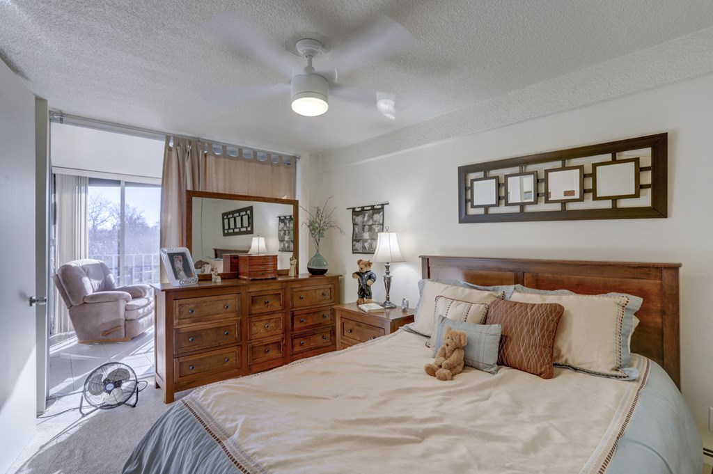 a bedroom with a bed and a dresser and a window