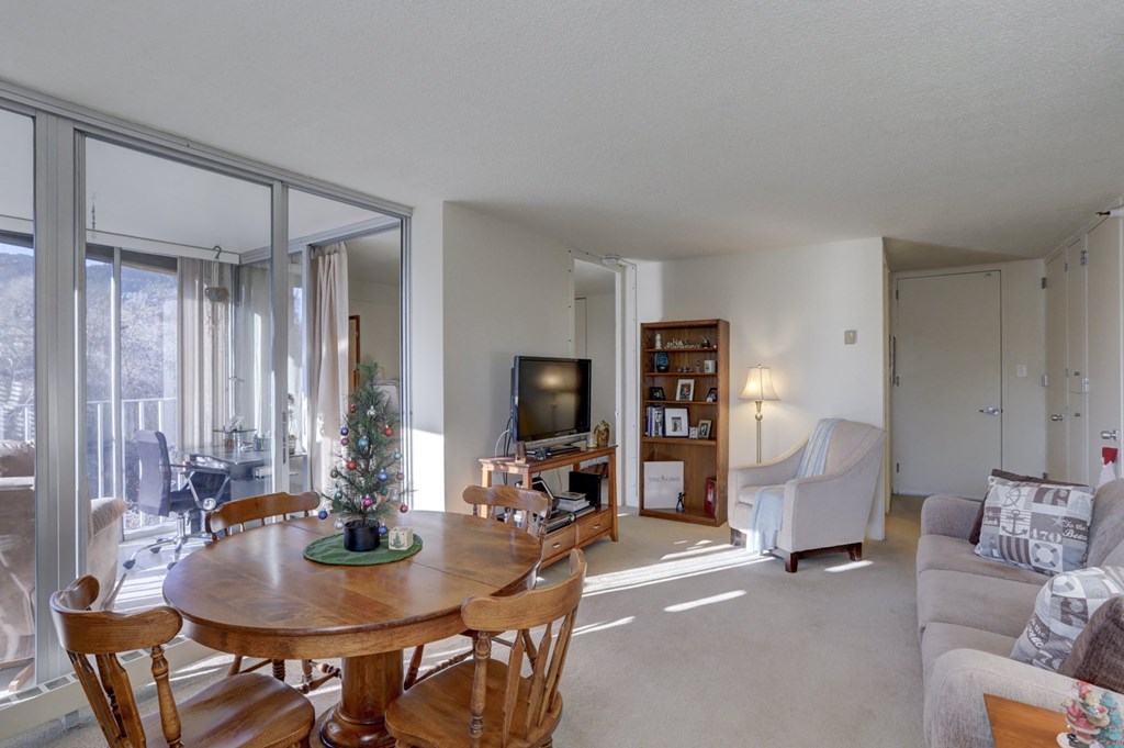 the living room and dining room with a christmas tree in the center of the