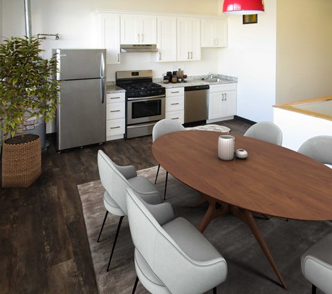 A modern kitchen with a dining table and chairs.